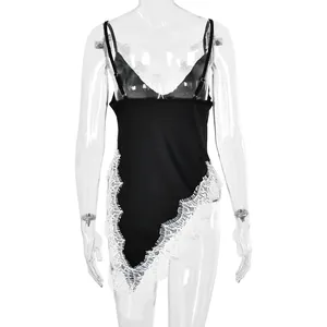 Detail of black slip dress with irregular hem and white floral lace trimming