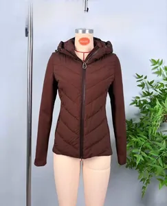 Detail of a dark brown hooded quilted jacket with V-shape stitching and zipper closure