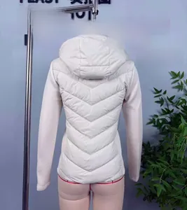 Detail view of cream hooded quilted jacket featuring V-shaped stitching and拼接sleeves