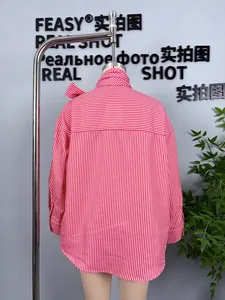 Detail view of pink striped shirt back featuring box pleat and bow-tie collar
