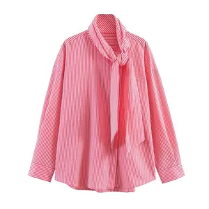 Detail of pink and white striped shirt featuring adjustable bow tie neckline and soft cotton