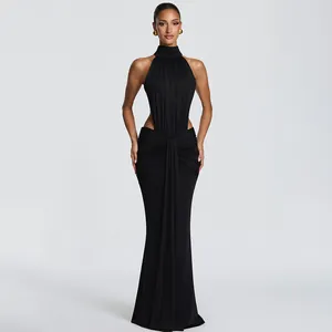 Detail of elegant black halter gown featuring waist cut-outs and ruching details