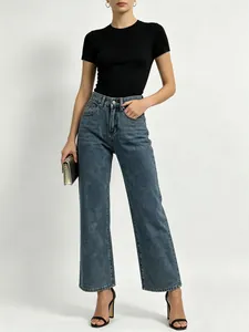 Detail of high-waisted wide-leg denim jeans with retro washed texture for women