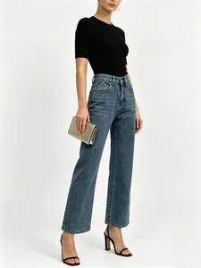 Detail of high waisted wide leg jeans showing blue denim wash and classic 5-pocket design