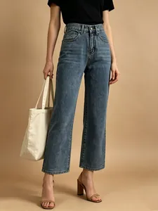 Detailed view of high-waist straight-leg jeans in vintage wash blue with five-pocket design