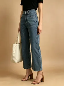 Detailed view of high-waisted wide-leg jeans in vintage wash blue with button fly