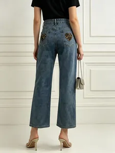 Close-up of leopard heart pattern pockets on blue vintage wide leg denim jeans