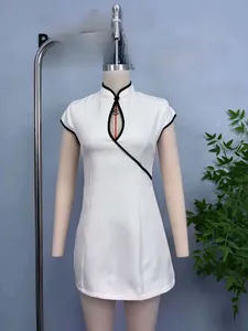 Close-up of modern white qipao dress with black contrast trim and teardrop neckline detail