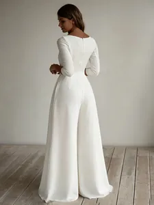 Elegant white wide-leg jumpsuit with three-quarter sleeves and back zipper detail
