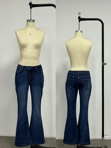 Detail of slim fit flare jeans in dark blue wash featuring five-pocket styling and denim texture