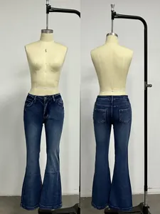 Detail of vintage blue flare jeans showing washed effect and bell bottom cut for women