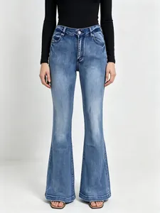 Detail of high-waisted flare jeans with vintage washed blue finish and metal button