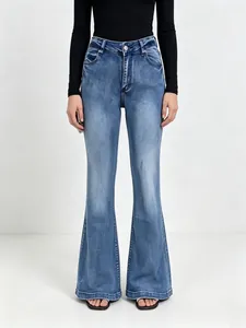 Front view of high waisted flared jeans with mid-blue wash and natural whiskers