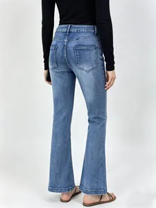 Detail view of high waist flared jeans with back pockets and subtle wash effect