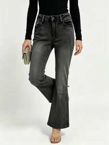 Close-up of vintage grey high-waisted flared jeans with washed denim texture and slim fit