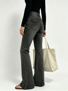 Rear view of slim fit flared jeans in dark grey denim with functional back pockets