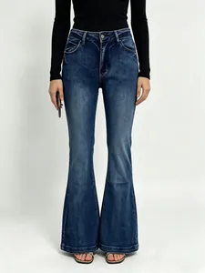 Detailed close-up of dark blue washed flare jeans showing high waist fit and denim texture