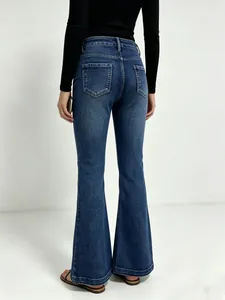 Macro view of dark blue flare jeans featuring back pockets and washed texture