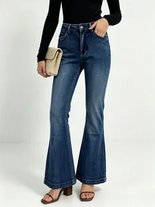 Close-up of high waist flare jeans in dark blue with natural washed denim texture