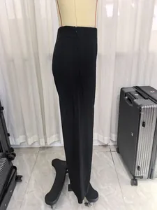Detailed side view of high-waist black trousers with invisible zipper on mannequin