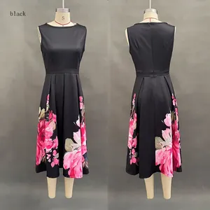 Detail view of sleeveless black midi dress featuring pink floral print and pleated skirt