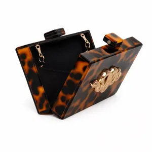 Tortoiseshell acrylic evening clutch bag with gold snake ornament and chain strap