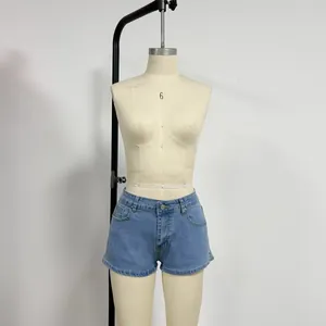 Detailed front view of light blue denim shorts with side slit on a dress form mannequin