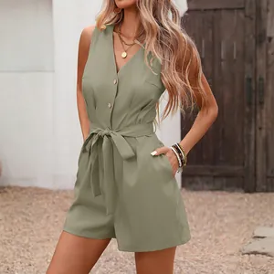 Detail view of sage green V-neck sleeveless romper with button front and tie waist