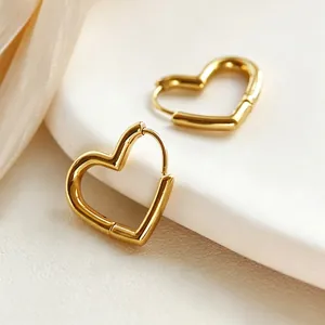 Polished 18K gold heart-shaped hoop earrings with minimalist cutout design