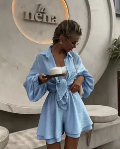 Detail of light blue two-piece set featuring pleated texture and tie-front waist shirt