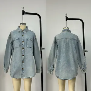 Detail view showing light wash denim fabric and amber buttons of the loose shirt