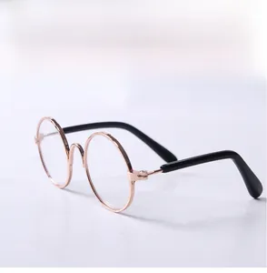 Detail view of round alloy frame pet sunglasses in rose gold with black temple tips
