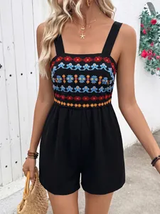 Close-up of bohemian multi-color embroidery on a black sleeveless summer romper