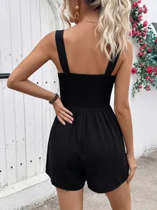 Detail view of the smocked back design on a black sleeveless summer vacation romper