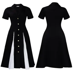 Détail de la robe contrastée noir et blanc avec boutons dorés et panneaux plissés