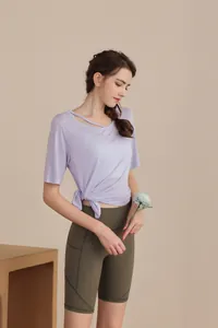 Detail of lavender sports top with side-tie knot and asymmetric hollow neckline