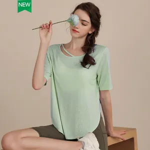 Women's light green tencel yoga t-shirt with cross-strap neck and curved hem detail