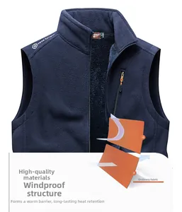 Detail of dark blue fleece vest featuring stand collar, zippers, and windproof fabric texture