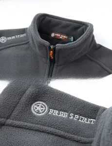 Detail showing the gray fleece vest neckline with Free Spirit logo embroidery and zipper