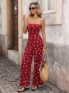 Close-up of red polka dot strapless jumpsuit fabric and waist detail in outdoor lighting