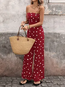 Close-up of retro red polka dot strapless jumpsuit with wide legs and flowing fabric