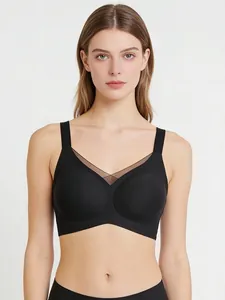 Close-up of black seamless V-neck bra with sheer mesh detail and wide shoulder straps