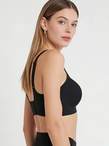 Close-up of seamless black wireless bra showing wide side wings for better support