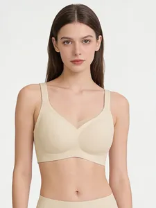 Detail of wire-free V-neck bra with mesh stitching and seamless nude fabric texture
