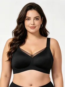 Detail of black wireless plus size sports bra with V-neck mesh panels and wide straps