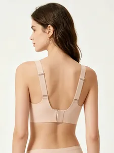 Detail view of seamless U-back wire-free bra with adjustable straps in nude color