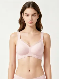 Detail of light pink seamless wire-free V-neck bra with cross-strap accent and wide straps