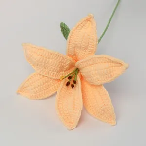 Handmade crochet lily flower in creamy orange yarn with green stem and leaf
