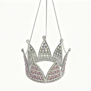 Detail view of silver crown pendant featuring pink rhinestones and hanging chains