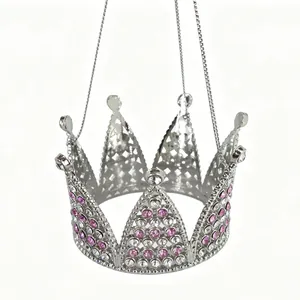 Close-up of silver baby crown pendant with pink and white rhinestones and hanging chain